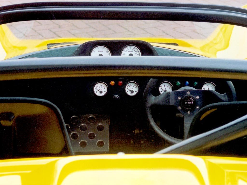 Cockpit and steering wheel of a yellow Ultima Can-Am