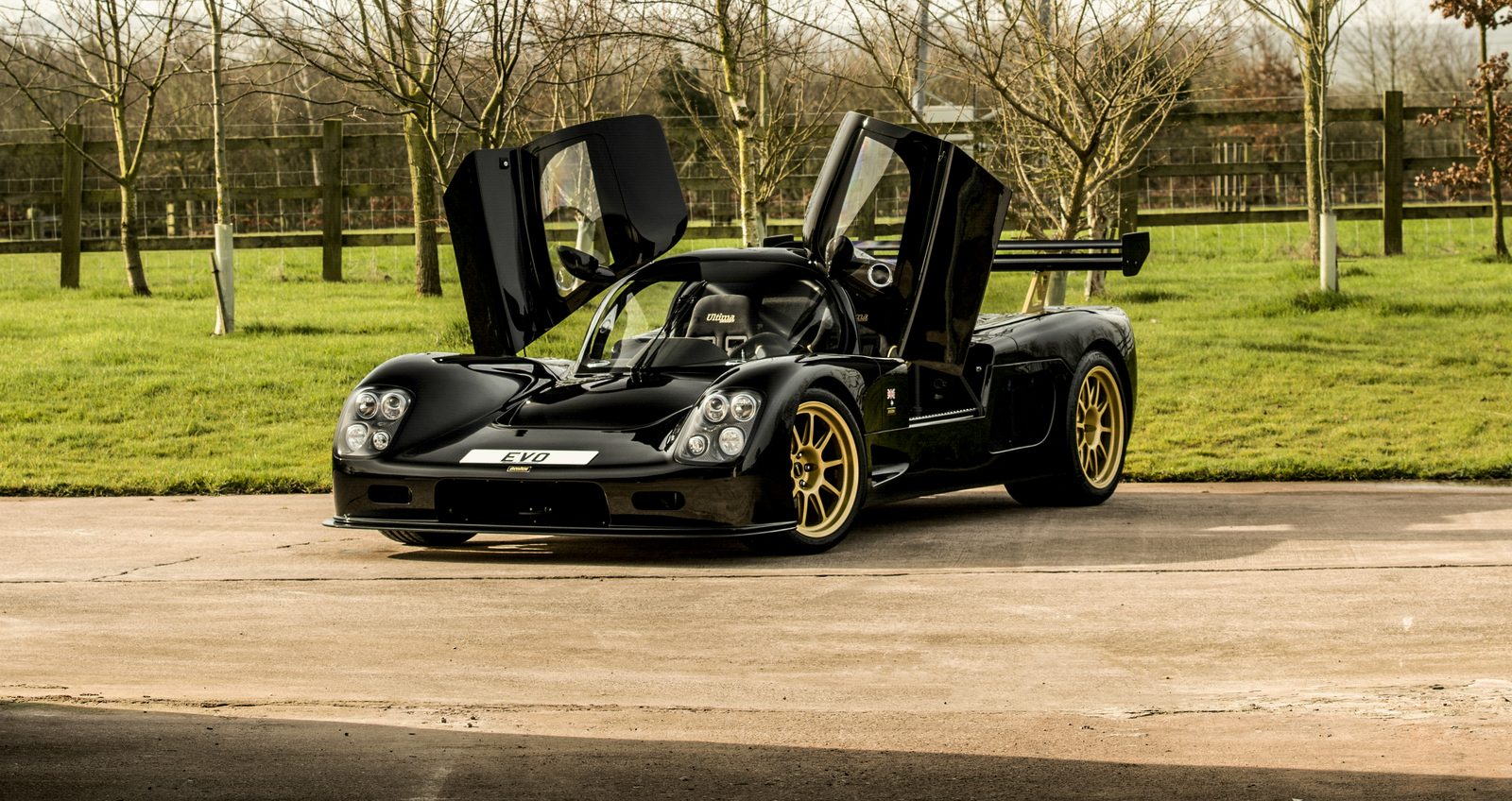 Black Ultima Evolution Coupe with its doors open
