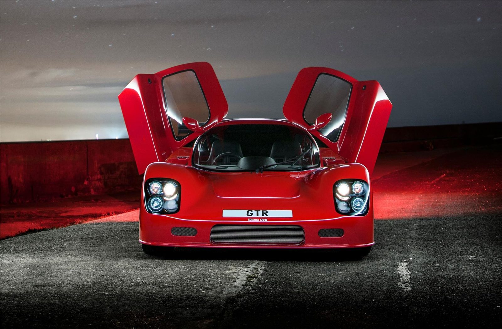 Red Ultima GTR photographed with both doors open
