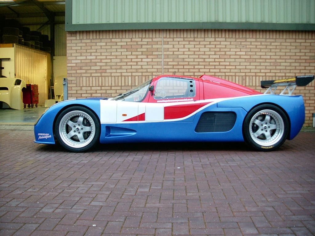 A blue and red Ultima GTR photographed from the side