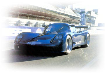A blue Ultima GTR photographed at a circuit