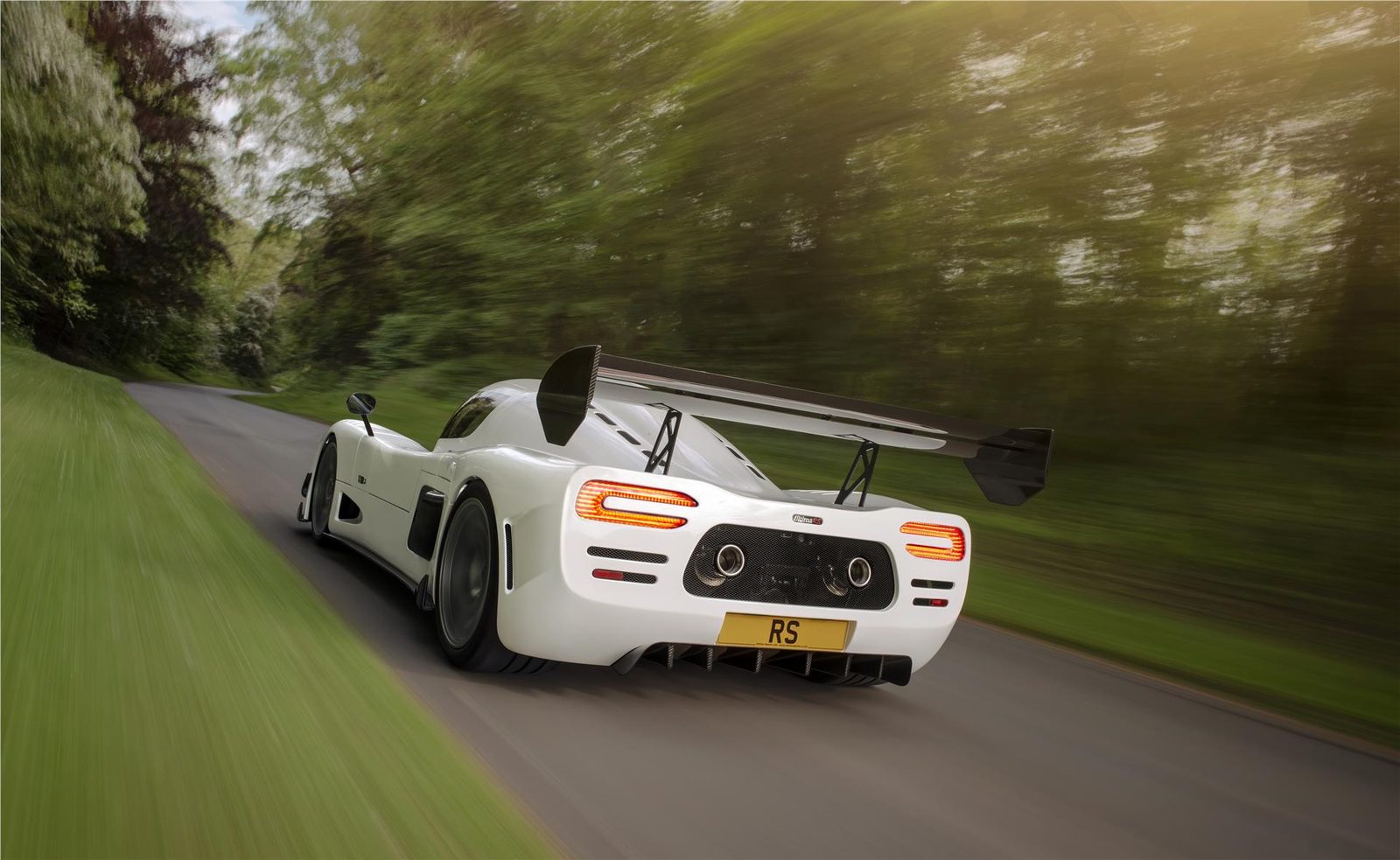 White Ultima RS photographed from behind on a road