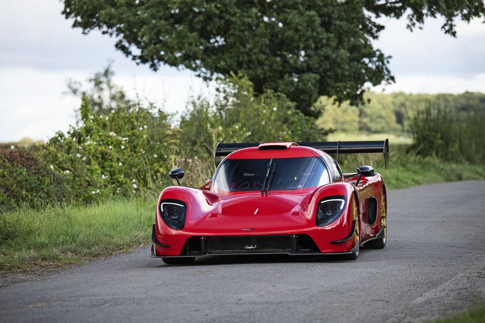 Red Ultima RS photographed on a country road