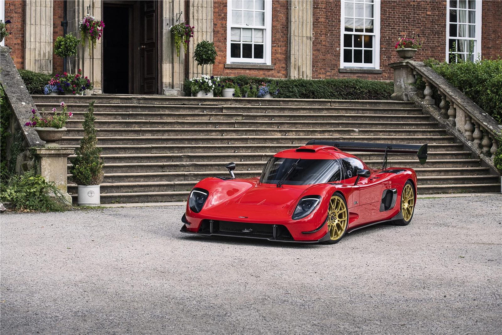 Red Ultima RS parked outside a house