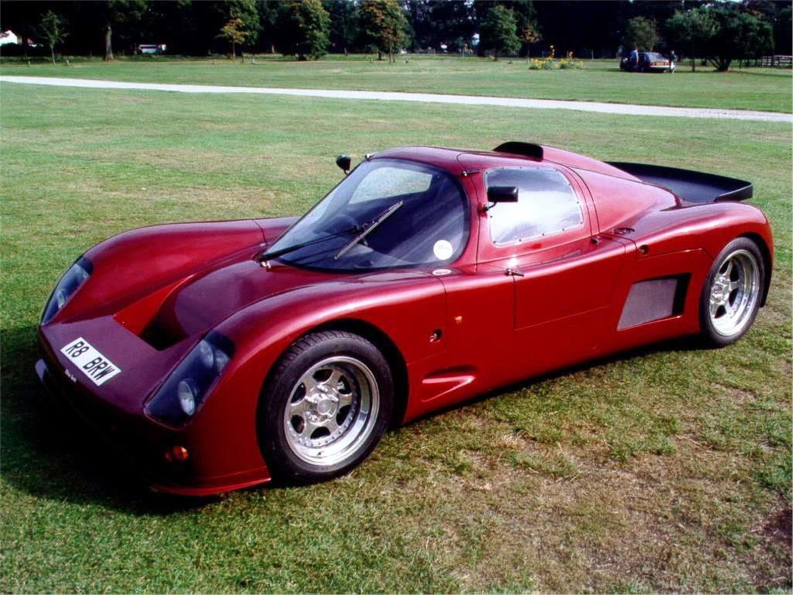 Red Ultima Sport in side view on grass