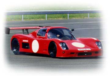 A red Ultima Sport photographed on a race circuit
