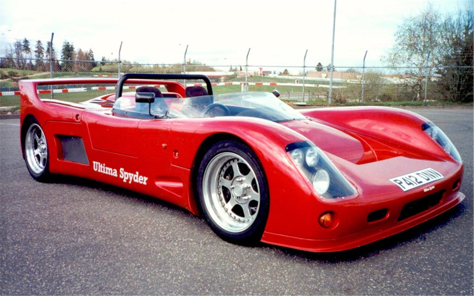 Red Ultima Spyder in front three-quarter view