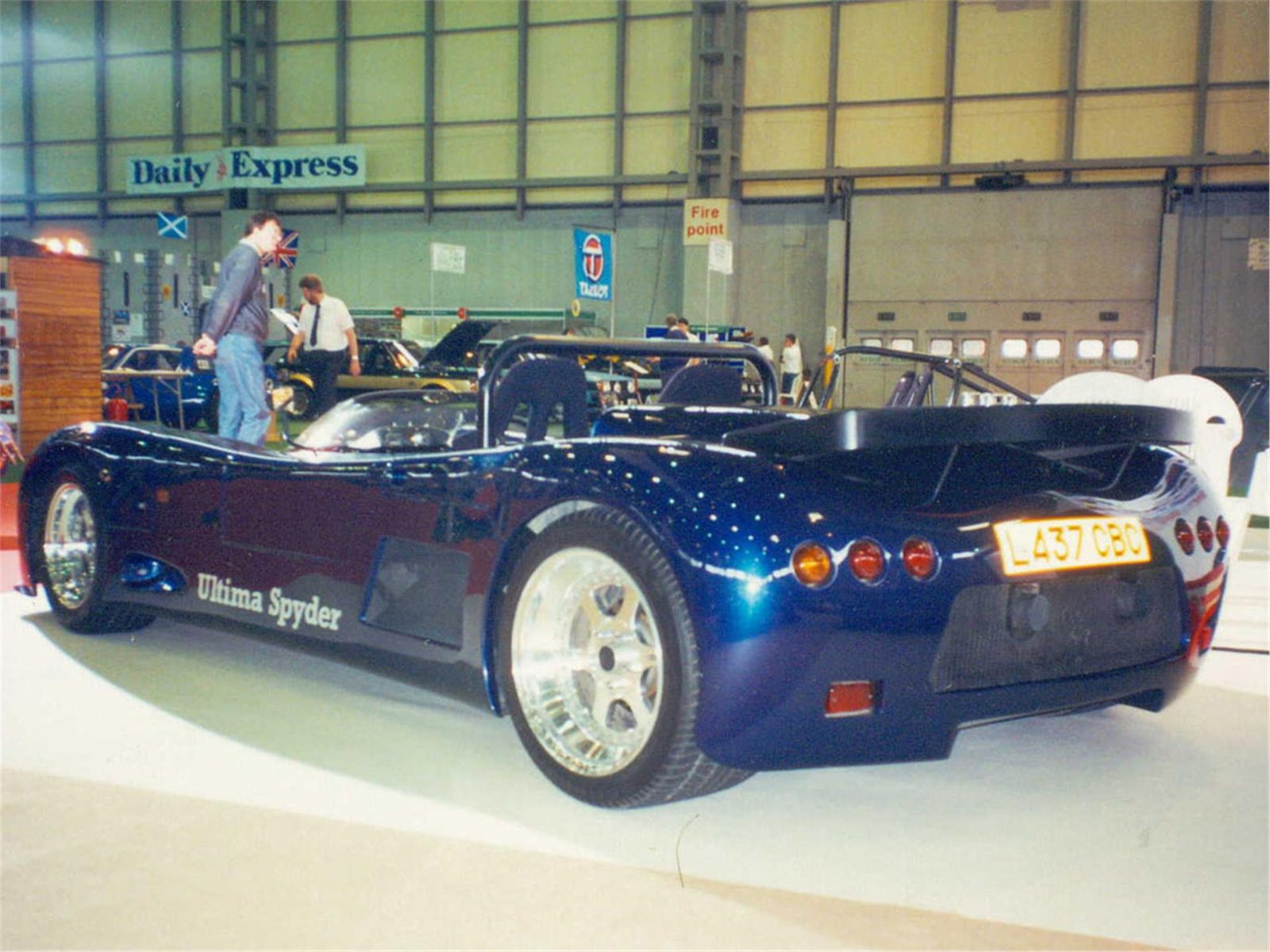 Blue Ultima Spyder displayed indoors