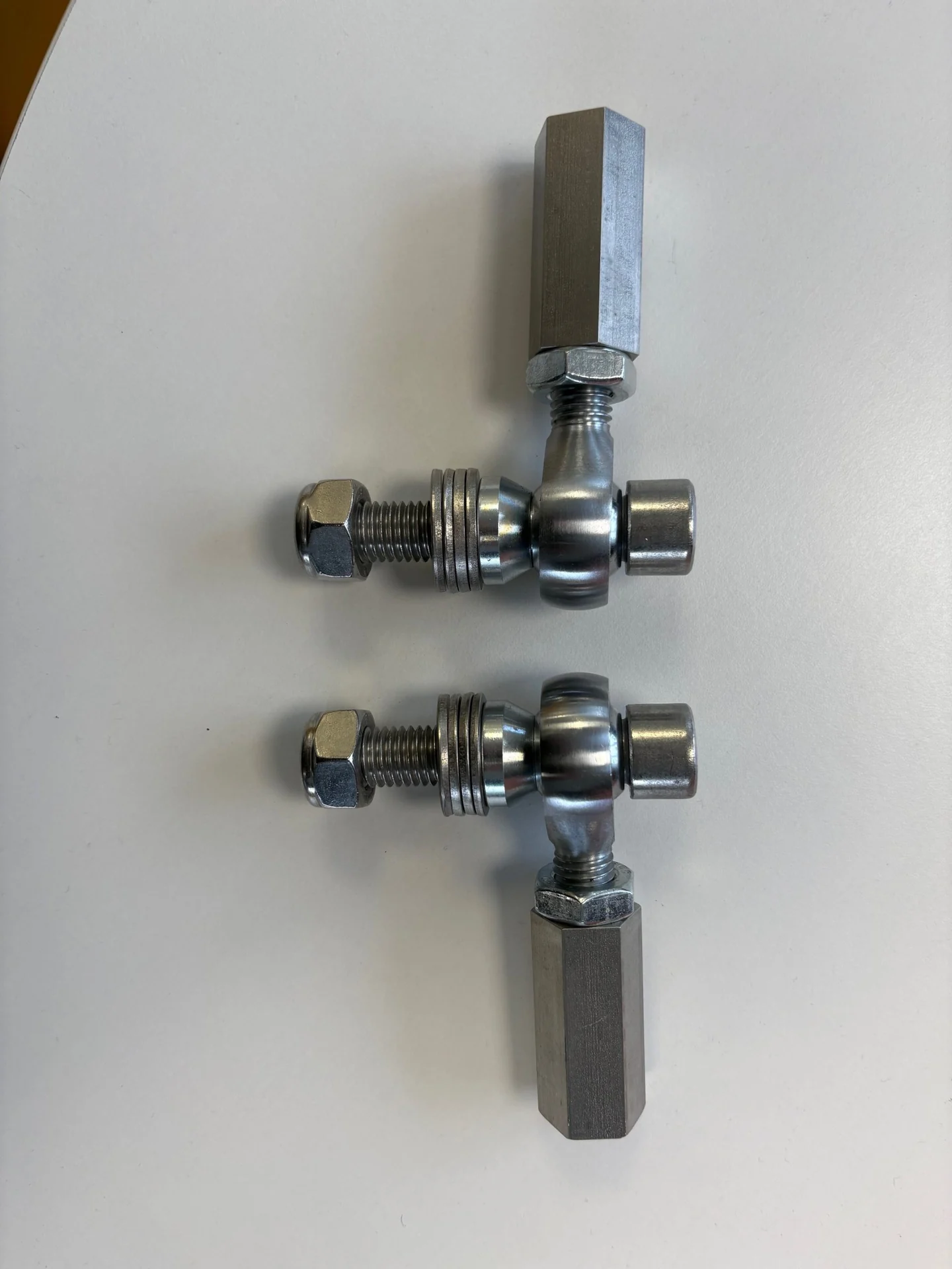 Pair of bump-steer adjusters arranged at right angles
