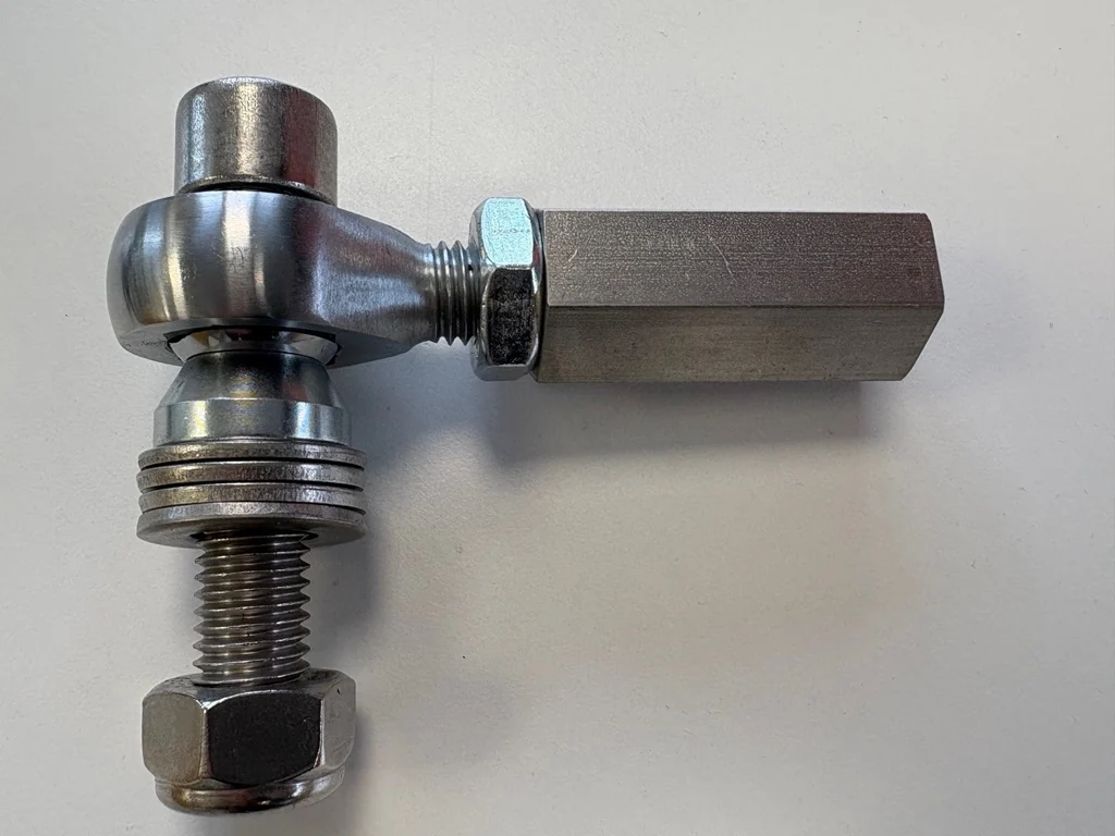 Close-up of a single bump-steer adjuster and rod end