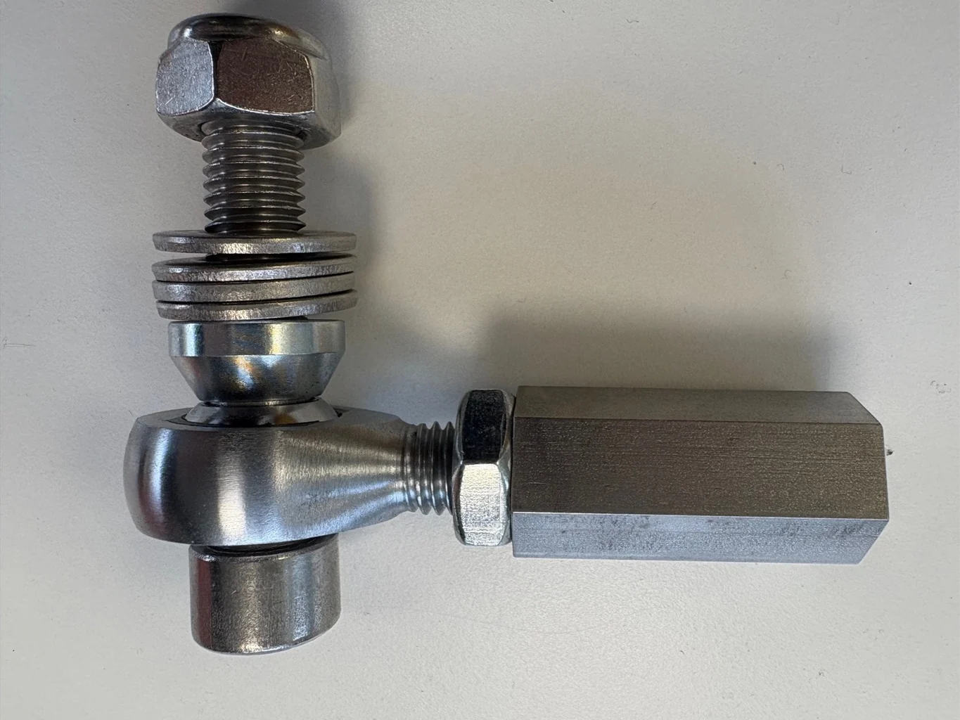 Close-up of a single bump-steer adjuster on a white background