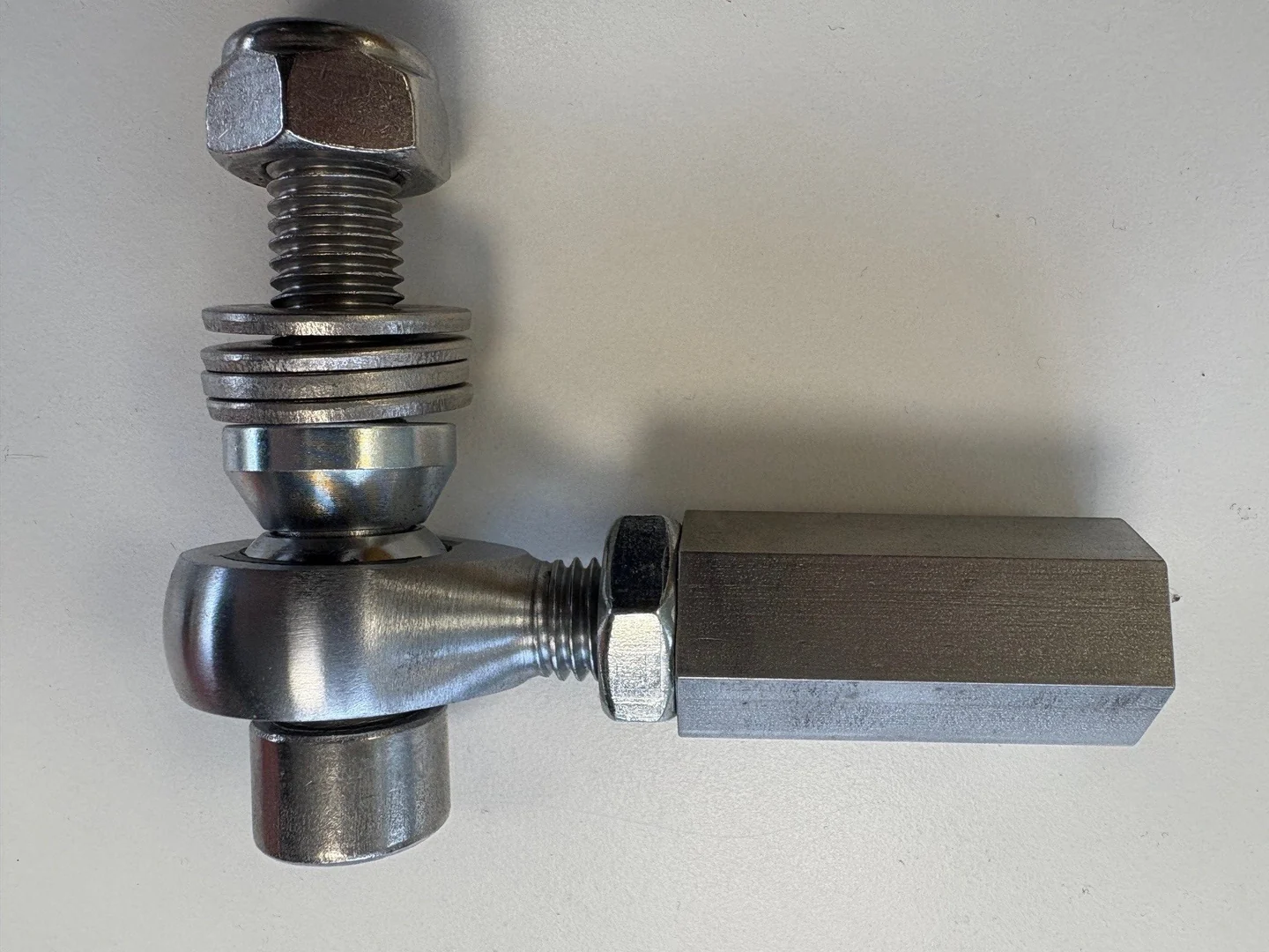 Close-up of a single bump-steer adjuster on a white background