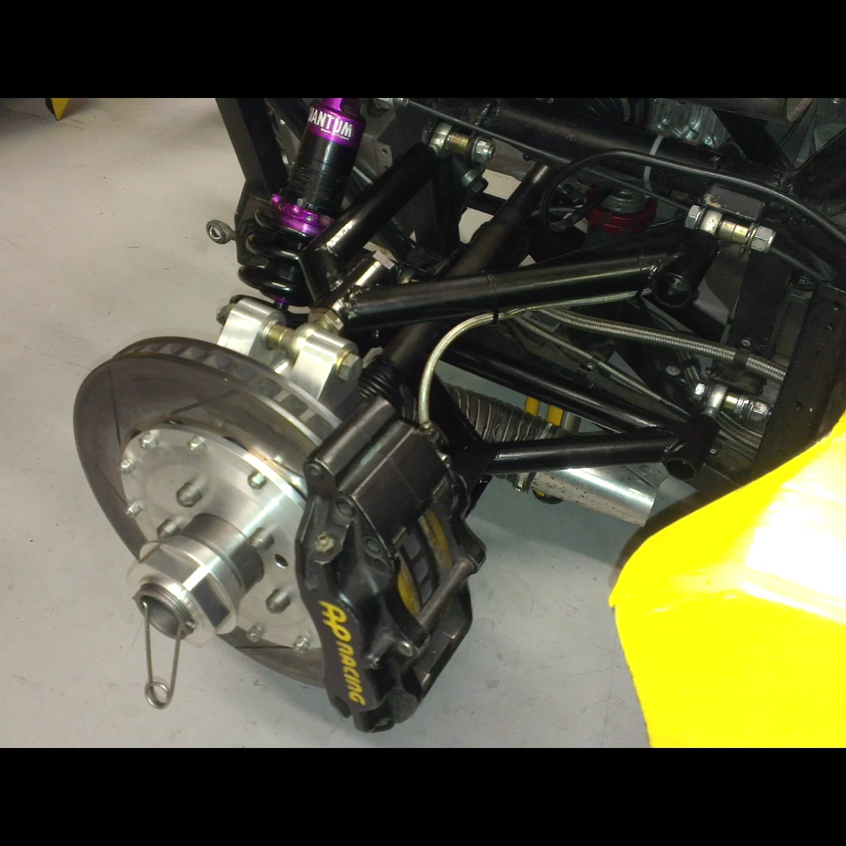 Rear wishbones fitted to an Ultima with wheel removed