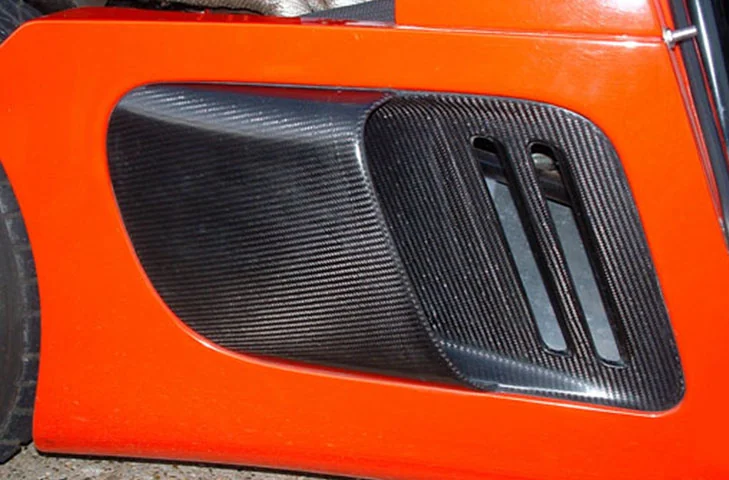 Close view of the driver-side carbon intake fitted flush in the bodywork.