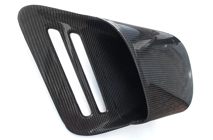Driver-side carbon-fibre intake duct viewed into the inlet opening.