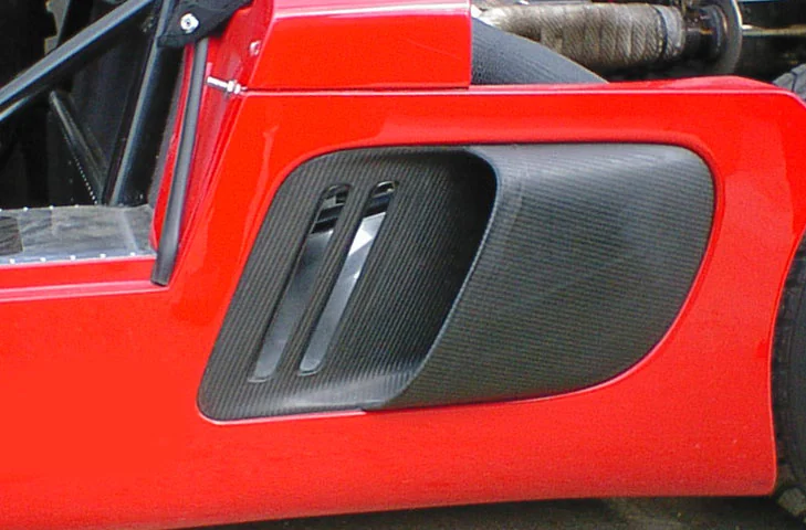 Close view of the passenger-side carbon intake fitted flush in the bodywork.