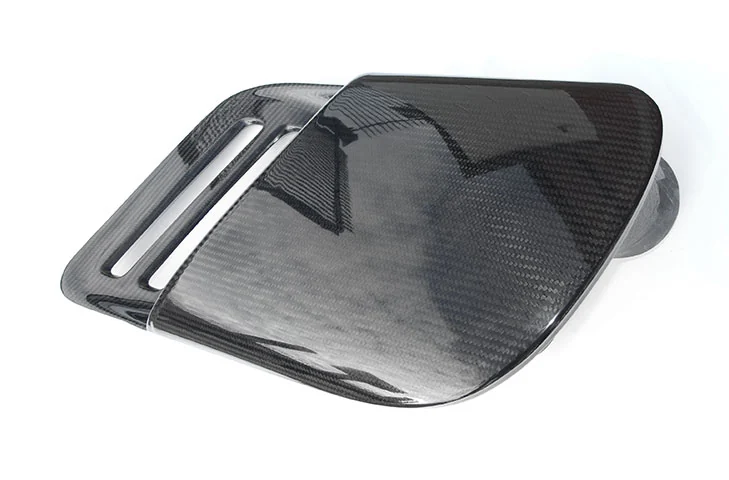 Passenger-side carbon-fibre intake duct viewed from above at an angle.