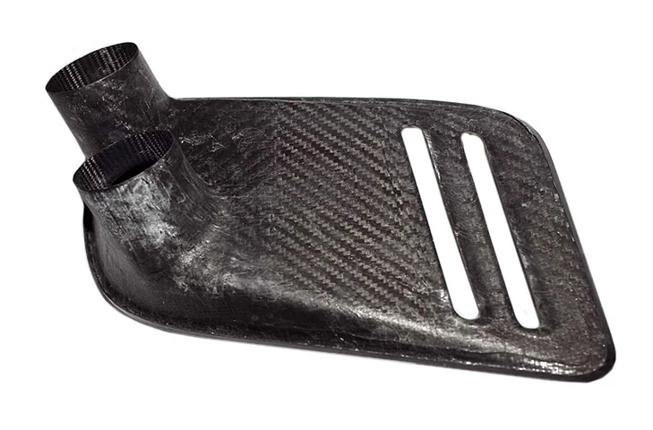 Rear of the passenger-side carbon intake, showing the moulded duct outlets.
